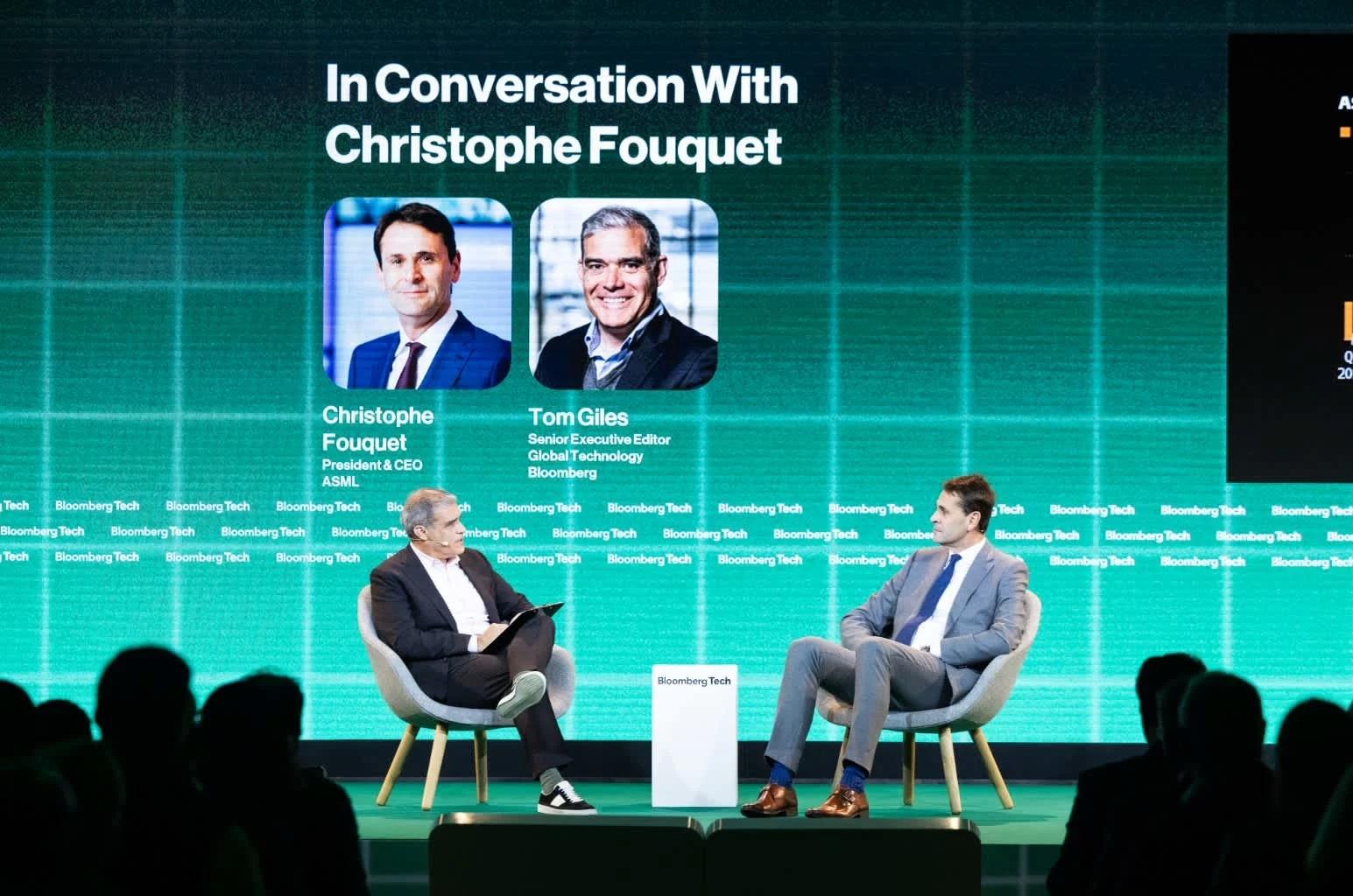 Person sitting on stage presenting